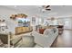 Bright living room features a ceiling fan, lots of seating, and access to the kitchen and dining area at 3990 Hillyard St, North Charleston, SC 29405