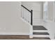 Classic staircase featuring dark-stained wood steps with white risers and decorative wood wainscoting at 3990 Hillyard St, North Charleston, SC 29405