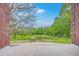 A serene backyard view featuring lush greenery, mature trees, and a blue sky, perfect for relaxation at 404 Fairington Dr, Summerville, SC 29485