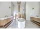 A luxurious bathroom featuring double vanities, marble tiling, modern fixtures, and a freestanding tub at 404 Fairington Dr, Summerville, SC 29485