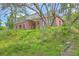 Charming red brick home with a covered porch and a lush green lawn at 404 Fairington Dr, Summerville, SC 29485