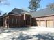 A beautiful brick home boasts a spacious three-car garage and concrete driveway at 404 Fairington Dr, Summerville, SC 29485
