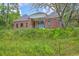 Lovely brick home on a slight hill featuring mature trees, lush green grass, and inviting design at 404 Fairington Dr, Summerville, SC 29485