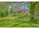 Picturesque home with mature trees, lush lawn, and a stately brick facade, offering charm and elegance at 404 Fairington Dr, Summerville, SC 29485