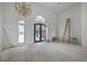 Bright, airy living room with tall ceilings and unique lighting, awaiting finishing touches and decor at 404 Fairington Dr, Summerville, SC 29485