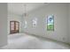 Bright and airy living room with large windows, custom door and modern light fixture; a blank canvas ready for your style at 404 Fairington Dr, Summerville, SC 29485