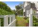 Private backyard featuring a pool, lush greenery and a fence offers a serene oasis at 407 Pitt St, Mount Pleasant, SC 29464