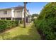 Well-manicured backyard with pool, hedges, and seating, offering privacy and charm at 407 Pitt St, Mount Pleasant, SC 29464