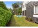 Backyard area with a pool, surrounded by lush greenery, ideal for outdoor enjoyment at 407 Pitt St, Mount Pleasant, SC 29464
