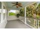 Outdoor balcony with ceiling fan provides a relaxing space amidst lush greenery and a tranquil atmosphere at 407 Pitt St, Mount Pleasant, SC 29464