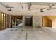 Unfinished basement with concrete flooring, block walls and exposed ceiling with mounted garage door openers at 407 Pitt St, Mount Pleasant, SC 29464