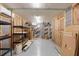 Partially finished basement with shelving, insulation, and a smooth epoxy floor at 407 Pitt St, Mount Pleasant, SC 29464