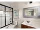 Bathroom featuring framed mirror, vanity, and tiled shower with glass doors at 407 Pitt St, Mount Pleasant, SC 29464