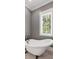 Modern bathroom features clawfoot soaking tub and natural light at 407 Pitt St, Mount Pleasant, SC 29464
