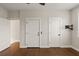 Spacious bedroom with hardwood floors, neutral walls, and a convenient TV mount offers comfort and style at 407 Pitt St, Mount Pleasant, SC 29464