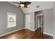 Bedroom with hardwood floors, ceiling fan, and large window at 407 Pitt St, Mount Pleasant, SC 29464