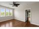 Inviting bedroom with a ceiling fan, three large windows, and hardwood floors exudes comfort and natural light at 407 Pitt St, Mount Pleasant, SC 29464