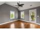 Bright bedroom with hardwood floors, fan, and access to a balcony at 407 Pitt St, Mount Pleasant, SC 29464