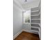 Well-organized closet with built-in shelving, a window for light, and elegant wood flooring at 407 Pitt St, Mount Pleasant, SC 29464