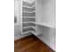 Spacious walk-in closet with custom shelving, bench, and wood flooring offers ample storage and organization at 407 Pitt St, Mount Pleasant, SC 29464