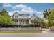 Stunning two-story home with a porch, black shutters, and a white picket fence for curb appeal at 407 Pitt St, Mount Pleasant, SC 29464