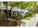 Beautifully landscaped front yard with mature trees and colorful flower beds at 407 Pitt St, Mount Pleasant, SC 29464