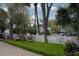 Landscaped yard with flowering azaleas around a white picket fence and gravel driveway at 407 Pitt St, Mount Pleasant, SC 29464