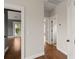 Bright hallway with hardwood floors offers easy access to multiple rooms and a charming outdoor balcony at 407 Pitt St, Mount Pleasant, SC 29464