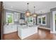Bright kitchen features a large island with white cabinets, marble countertops, and stainless steel appliances at 407 Pitt St, Mount Pleasant, SC 29464