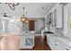Open kitchen layout featuring an island with seating, modern appliances, and seamless access to the staircase at 407 Pitt St, Mount Pleasant, SC 29464