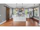 Spacious kitchen with white cabinets, marble countertops, stainless steel appliances and an island with seating at 407 Pitt St, Mount Pleasant, SC 29464