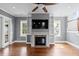 Bright living room with fireplace, built-in shelving, and access to a porch offering seamless indoor-outdoor living at 407 Pitt St, Mount Pleasant, SC 29464