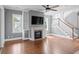 Comfortable living area with a fireplace, built-in shelves, and a ceiling fan for optimal air circulation at 407 Pitt St, Mount Pleasant, SC 29464