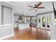 Open-concept living room showcasing hardwood floors, island kitchen, and double French doors at 407 Pitt St, Mount Pleasant, SC 29464