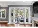 Cozy living room with fireplace and access to outdoor porch with comfortable seating and wooded view at 407 Pitt St, Mount Pleasant, SC 29464