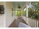 Screened-in porch with ceiling fan, wood floors, and nature views at 407 Pitt St, Mount Pleasant, SC 29464