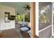 Outdoor living with seating, TV, and screened views of trees at 407 Pitt St, Mount Pleasant, SC 29464