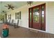 Welcoming porch with wooden floors, ceiling fans, and rocking chairs by the front door at 407 Pitt St, Mount Pleasant, SC 29464