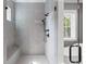 Modern shower featuring gray tiling, a rain shower head, and a built-in bench at 407 Pitt St, Mount Pleasant, SC 29464