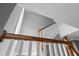 Elegant staircase with white spindles and stained wood handrail showcases the home's craftsmanship at 407 Pitt St, Mount Pleasant, SC 29464