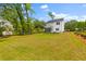Expansive backyard featuring lush green grass, a patio and a view of the house from the lawn at 481 Woodland Shores Rd, Charleston, SC 29412