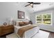 Stylish bedroom with shiplap accent wall, ceiling fan and bright, natural light at 481 Woodland Shores Rd, Charleston, SC 29412