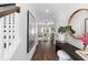 Inviting entryway with dark wood floors, white walls, staircase and decor leading to a bright living area at 481 Woodland Shores Rd, Charleston, SC 29412