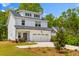Charming two-story home with black roof, white siding, two car garage, and a well manicured front yard at 481 Woodland Shores Rd, Charleston, SC 29412