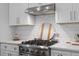 Bright kitchen features a stainless steel stove, white cabinets, quartz countertops and a subway tile backsplash at 481 Woodland Shores Rd, Charleston, SC 29412