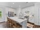 Bright kitchen with white cabinets, an island with seating, stainless steel appliances, and lots of natural light at 481 Woodland Shores Rd, Charleston, SC 29412