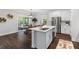 Modern kitchen featuring white cabinets, a central island with seating, and stainless steel appliances at 481 Woodland Shores Rd, Charleston, SC 29412