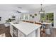 Open floor plan with a quartz countertop island, barstool seating and dining area with modern chandelier at 481 Woodland Shores Rd, Charleston, SC 29412