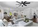 Open-concept living room with dark hardwood floors, light-colored furnishings, and seamless access to the kitchen at 481 Woodland Shores Rd, Charleston, SC 29412