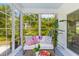 Sunroom with large windows providing lots of light, couch seating, hardwood floors and a view of the yard at 481 Woodland Shores Rd, Charleston, SC 29412